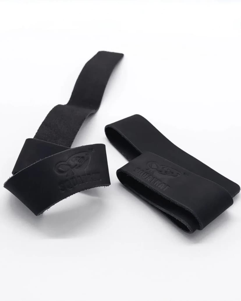 SQUATRAT suede leather lifting straps, black pair arranged in loops with embossed logos visible.